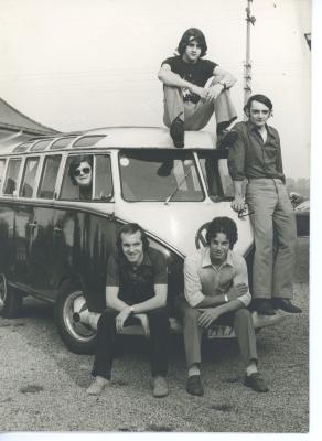 De leden van The Green Leaves poserend voor een VW-camper T1